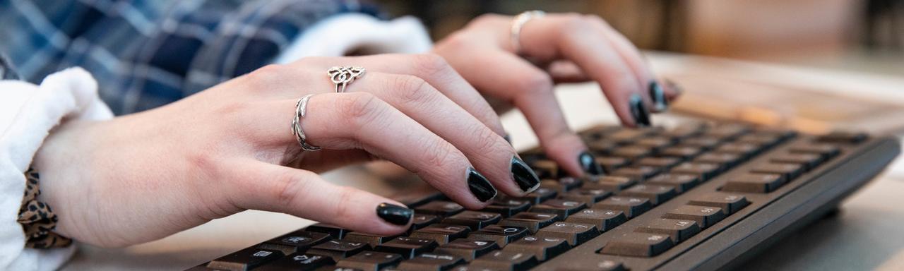 Person typing on keyboard